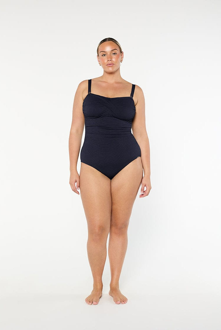 Woman wearing a black swimsuit on a white background