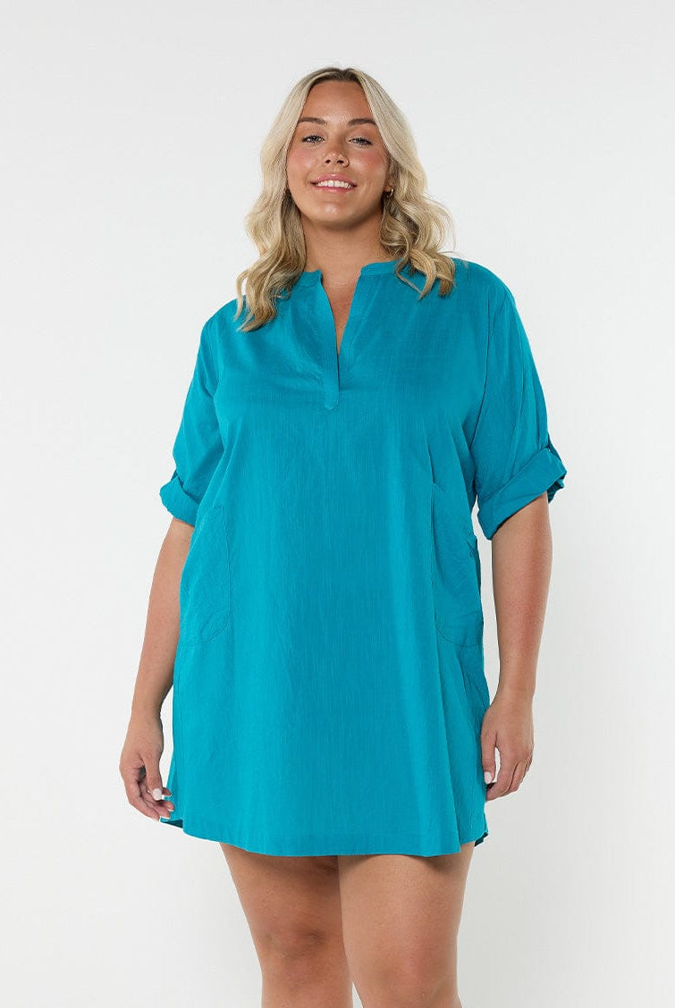 Blonde model in studio showing front of teal over shirt Australia