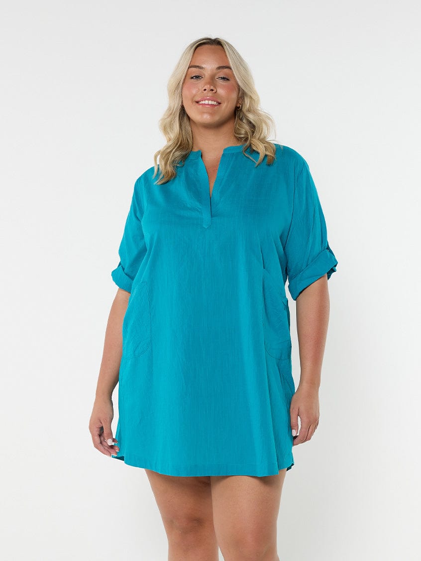 Blonde model in studio showing front of teal over shirt Australia