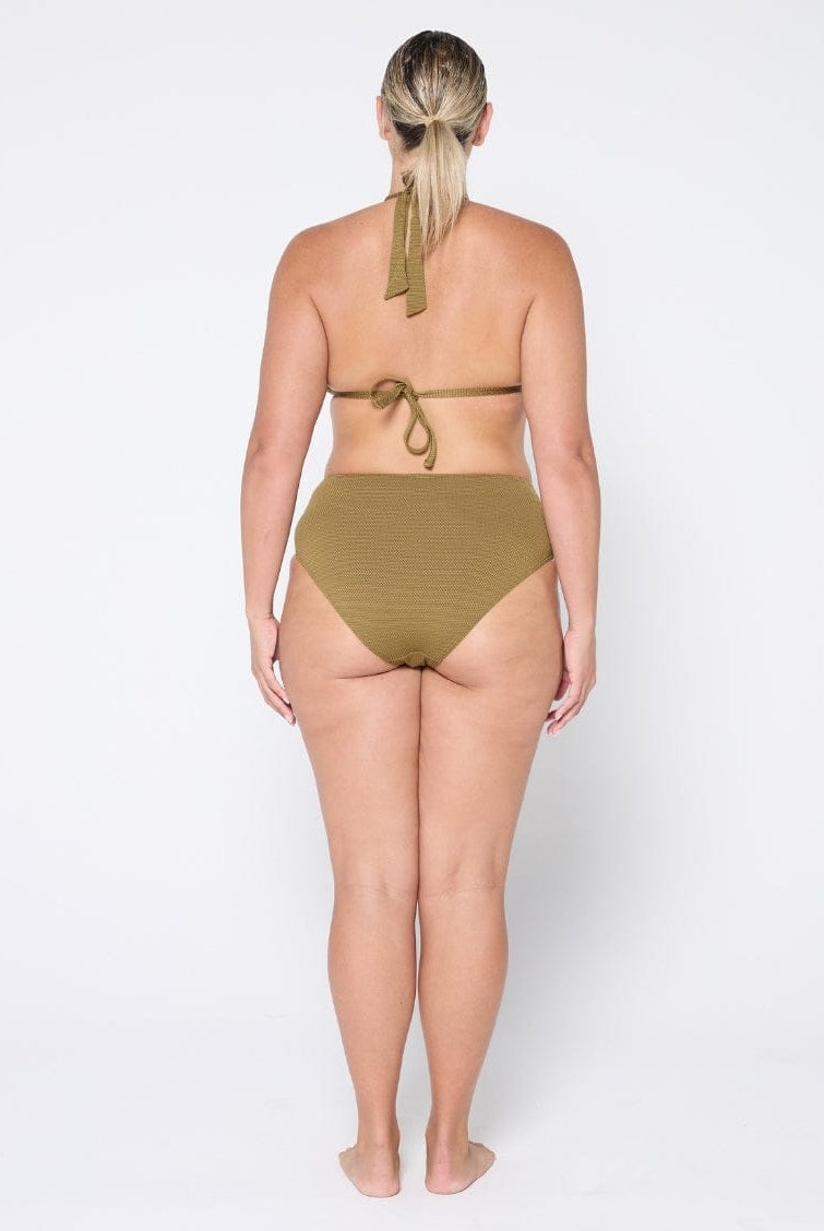 Woman wearing a green bikini on a white background