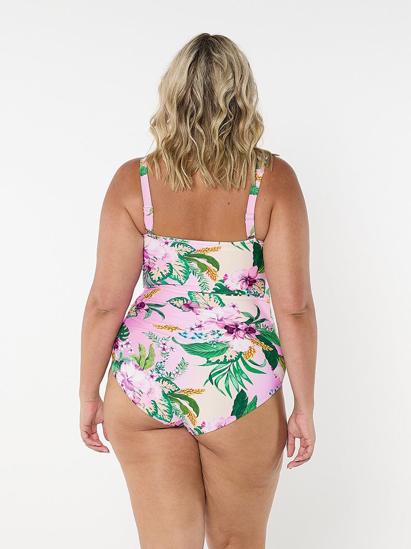 Back of model wearing tropical floral one piece with adjustable and removable straps