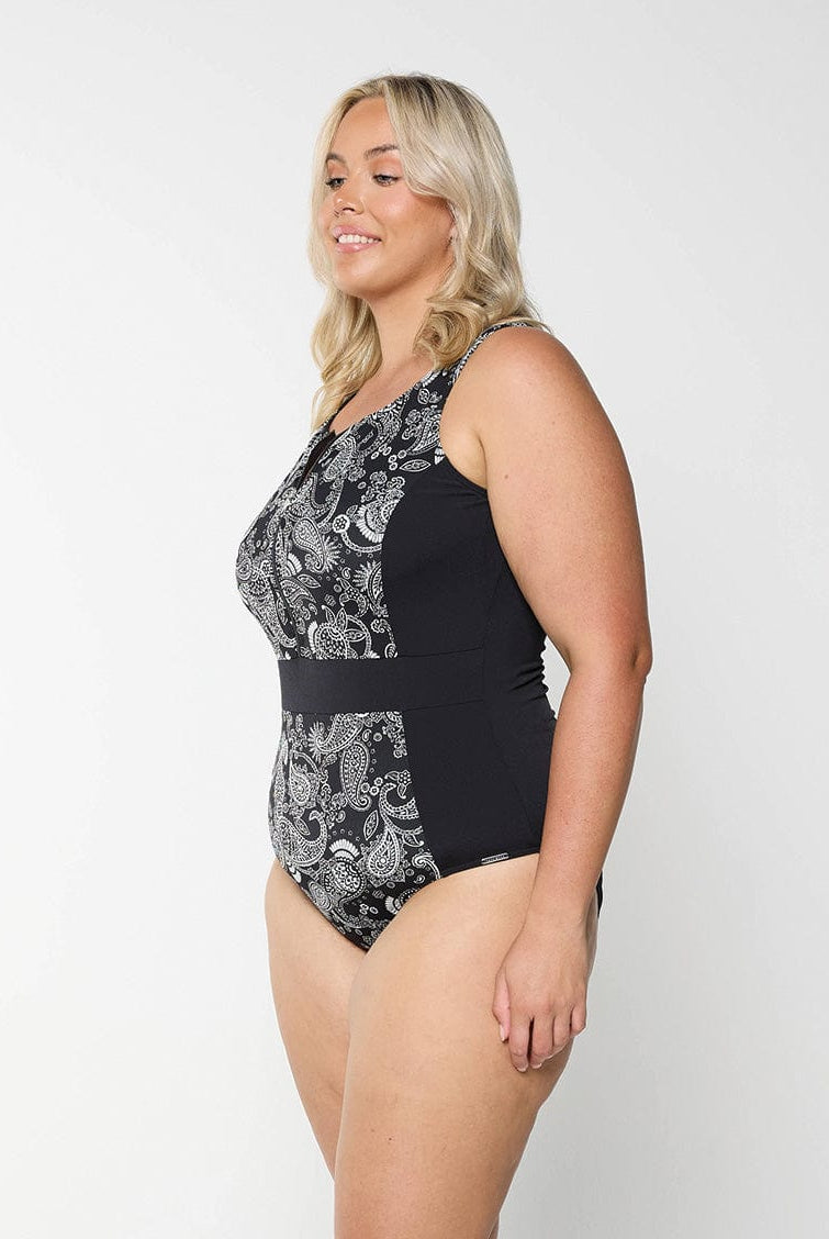 Side profile of blonde model in studio wearing zip front one piece in chlorine resistant