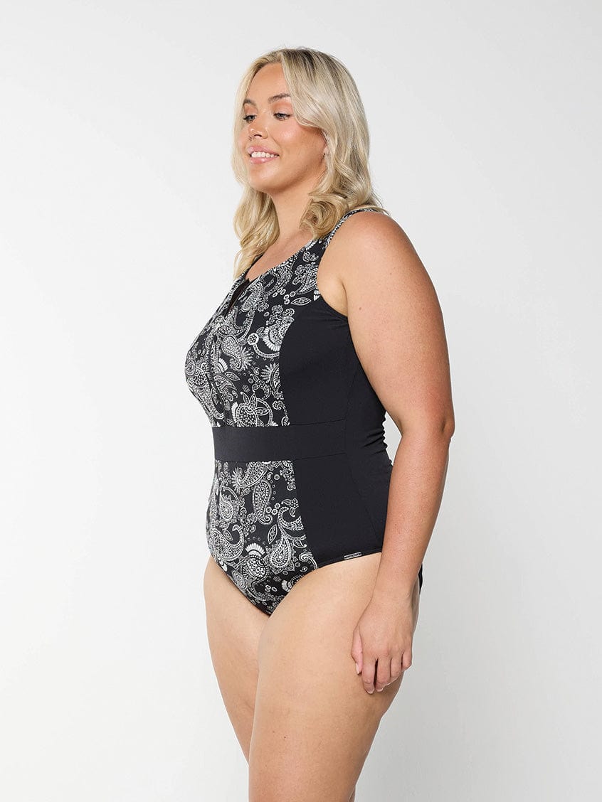 Side profile of blonde model in studio wearing zip front one piece in chlorine resistant