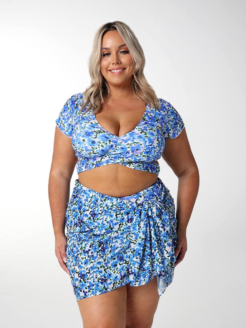 Front of model in studio wearing floral blue sarong