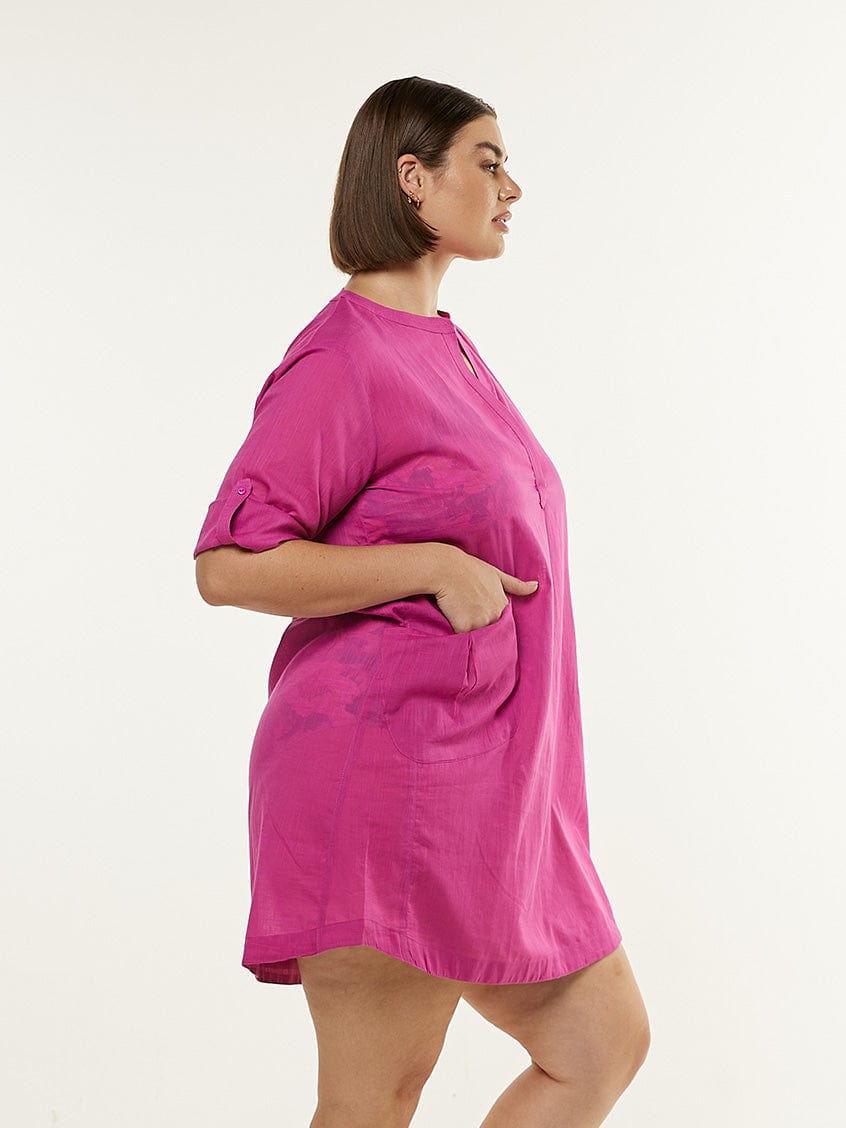 Model facing to the side wearing cotton over shirt in pink with pockets