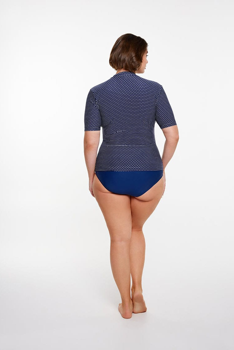 Person wearing a blue and white patterned swimsuit on a white background