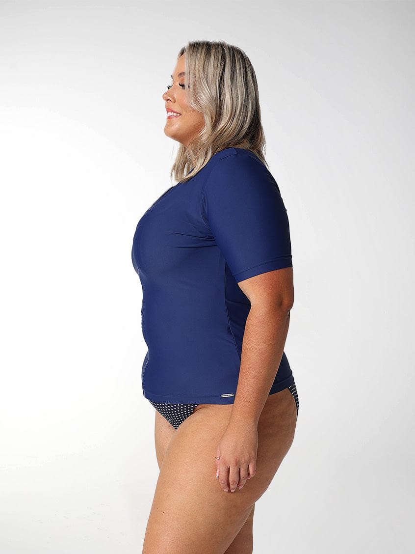 Woman wearing a navy blue rash vest