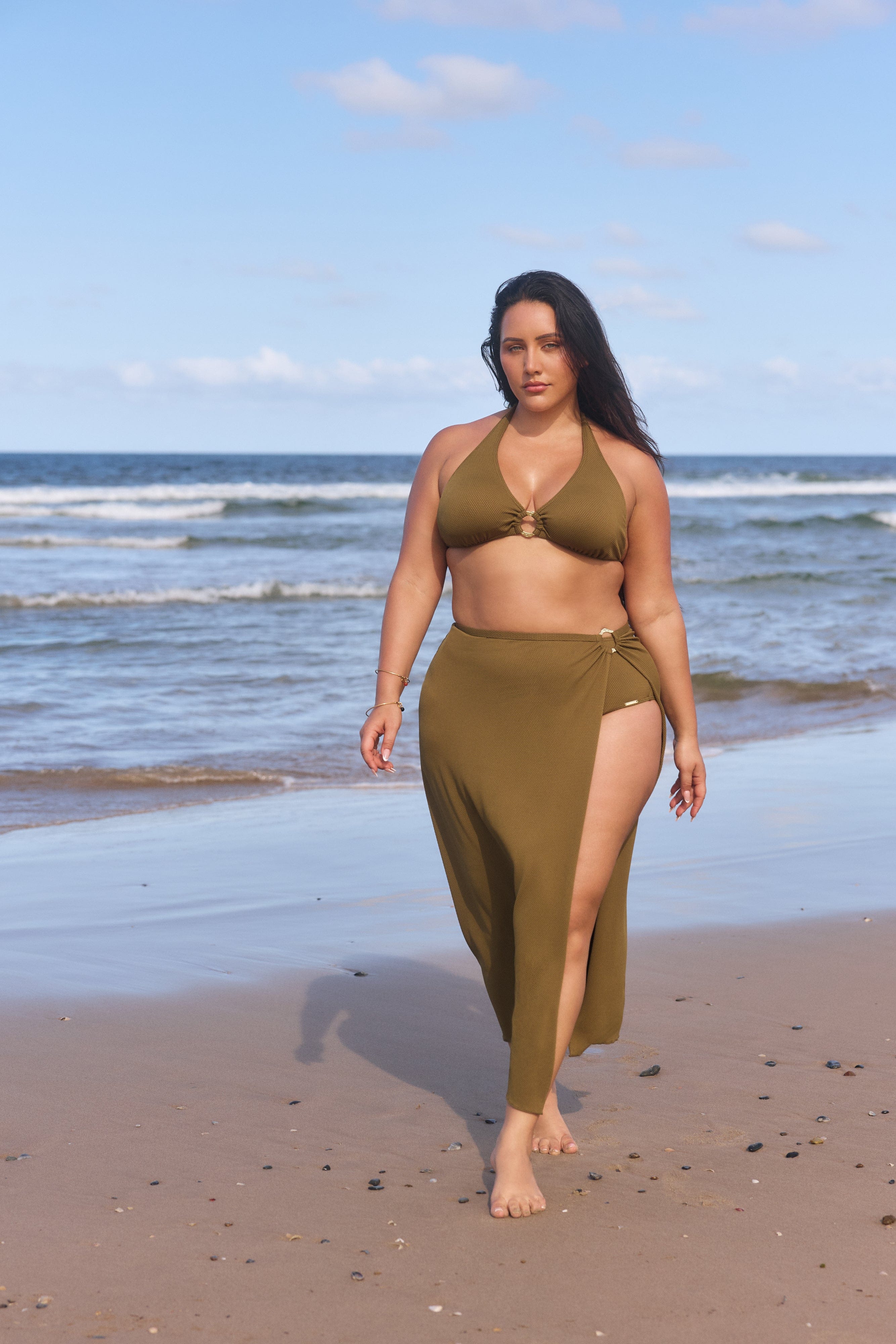 woman on beach wearing a khaki bikini with a long skirt