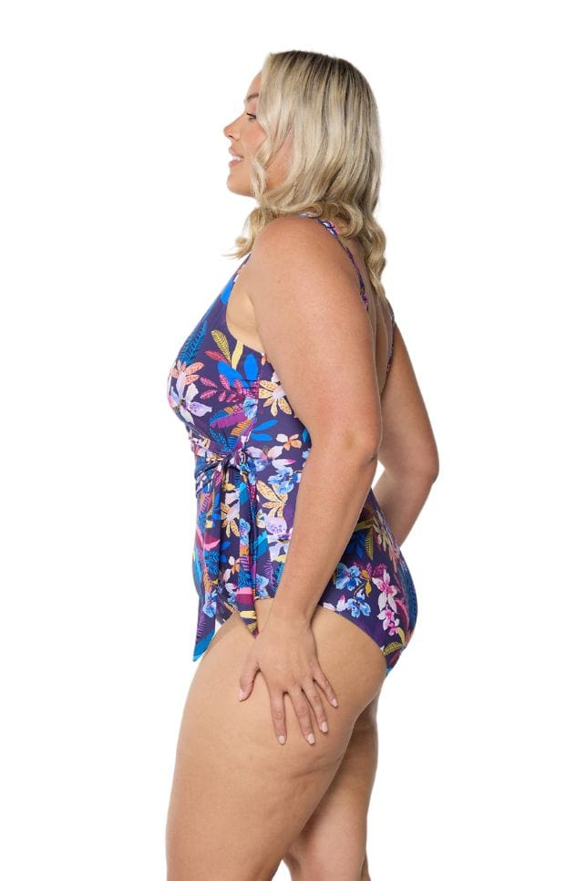 Side of curve model in studio wearing navy based one piece with tie side detail
