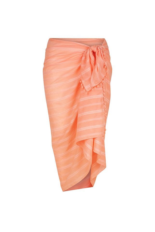 ghost mannequin image of coral cotton sarong with pom pom details on the sides
