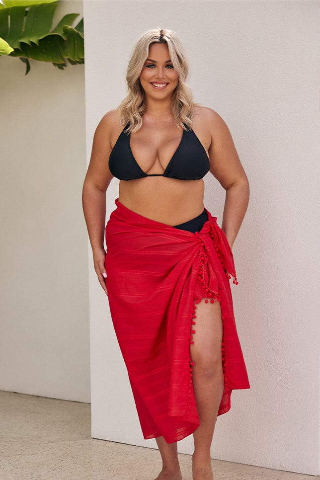 Blonde model wearing long red sarong