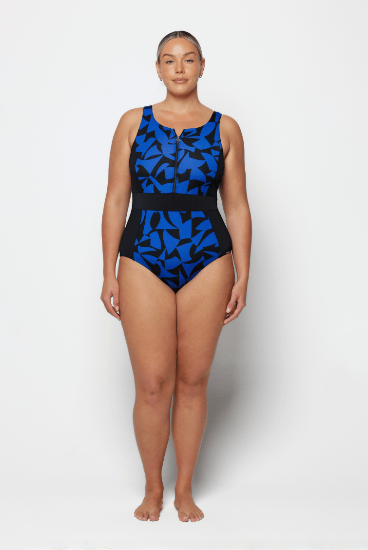 Woman wearing a blue and black patterned one-piece swimsuit on a white background
