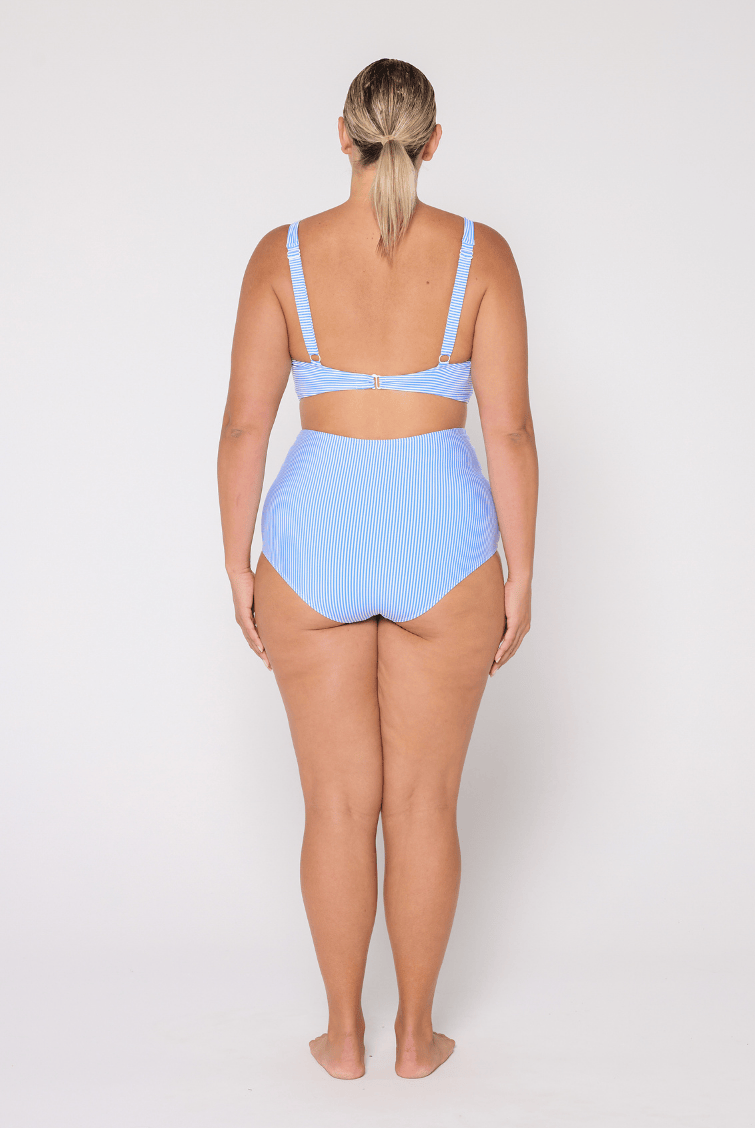 Woman wearing a light blue bikini set on a white background