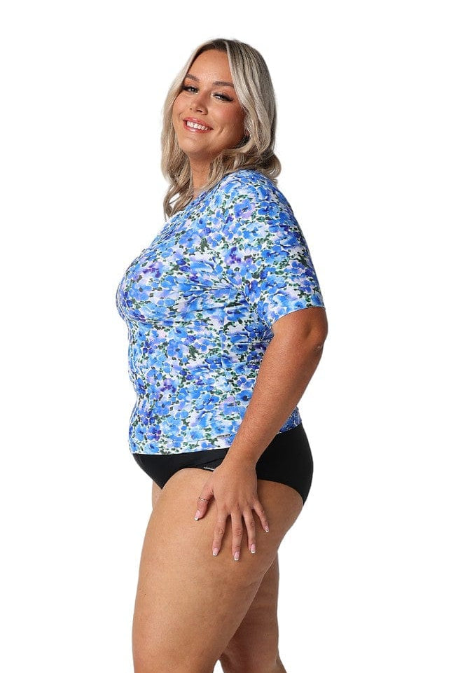 Side profile of blonde model wearing multicoloured floral rash shirt