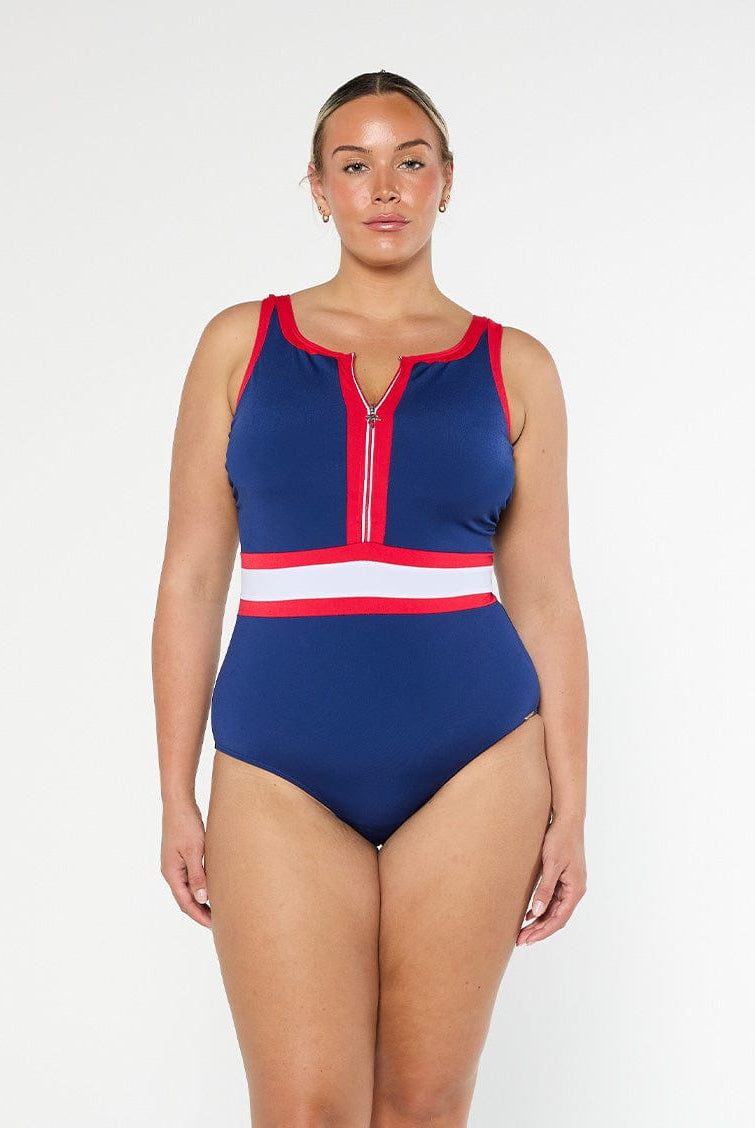 Woman wearing a blue and red swimsuit with a white stripe on a white background