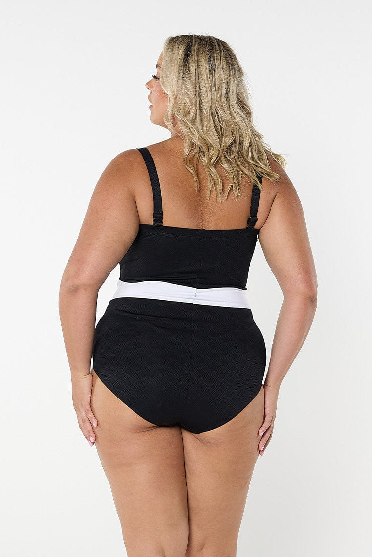 Woman wearing a black swimsuit with a white waistband on a white background