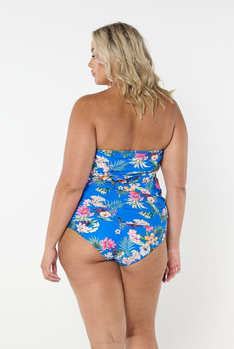 Blonde women shows the back of flattering blue floral tankini top with removable straps