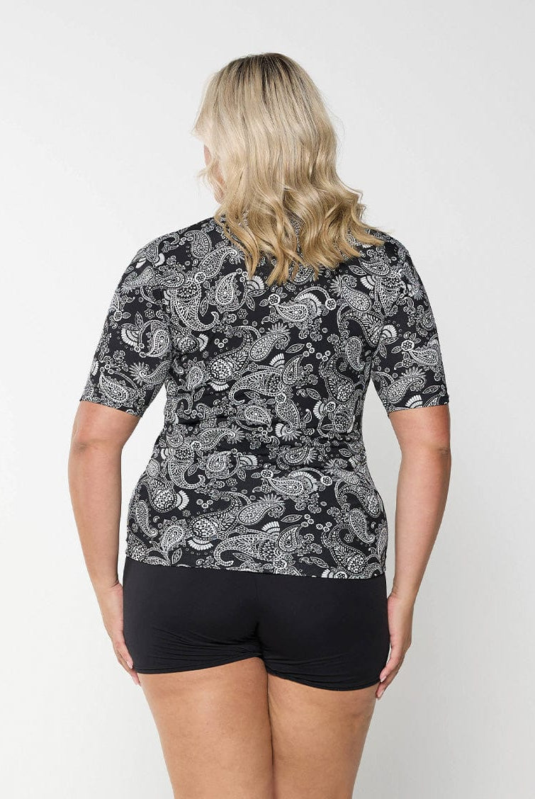 Back of model wearing rash vest with full zip through in paisley print for curve women