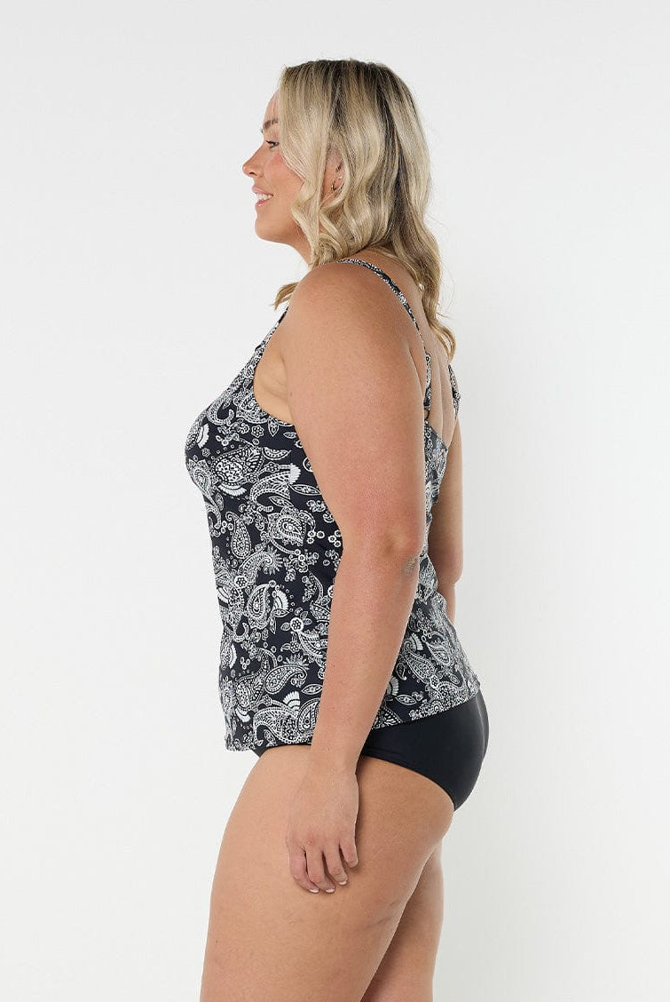 Side profile of blonde model in studio wearing tank tankini top for curve woman with adjustable straps
