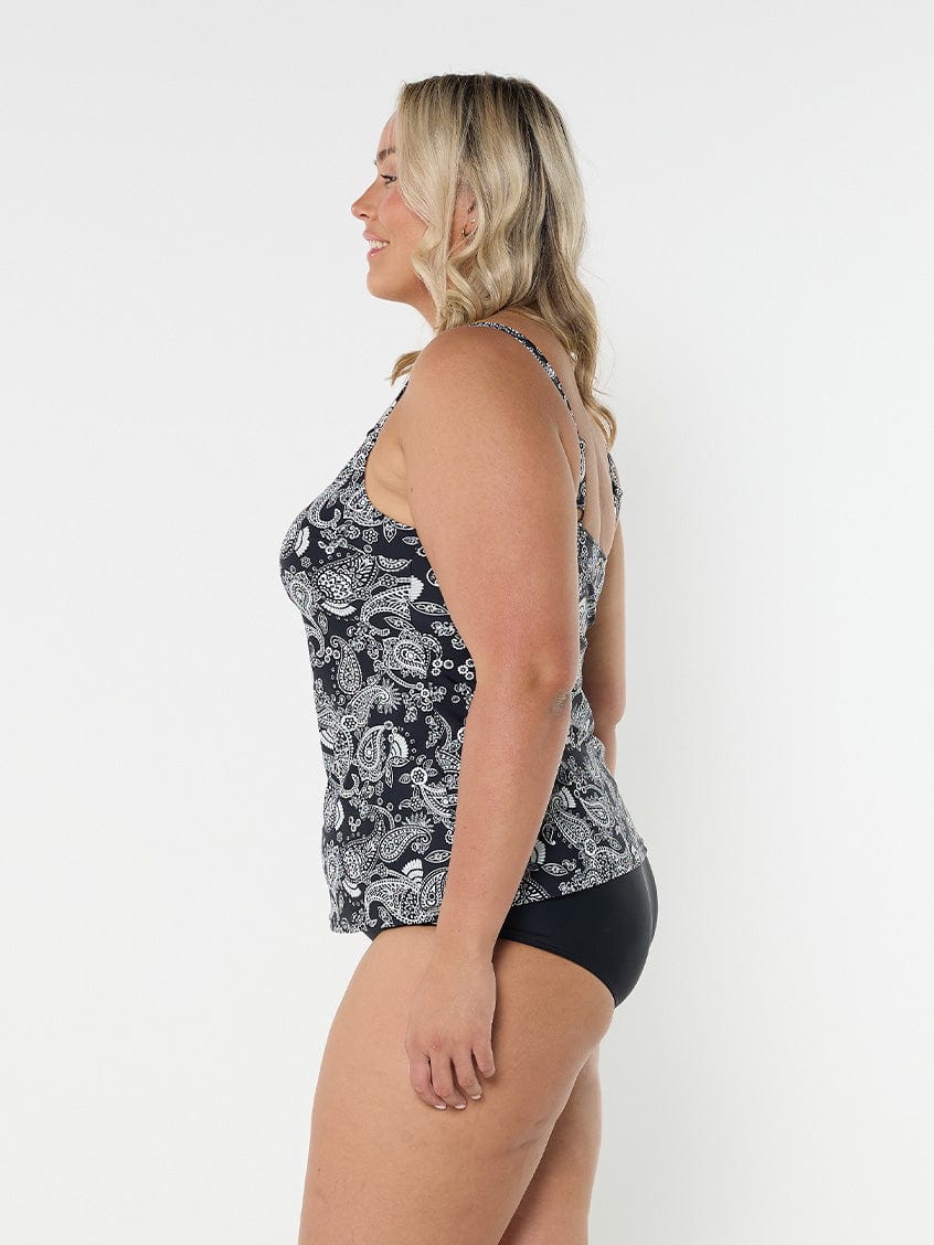 Side profile of blonde model in studio wearing tank tankini top for curve woman with adjustable straps