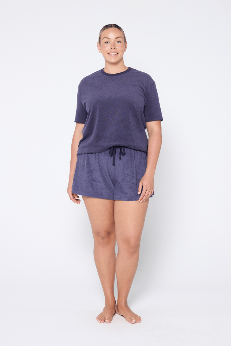 Blonde woman wearing a plus size terry towelling fabric top in navy