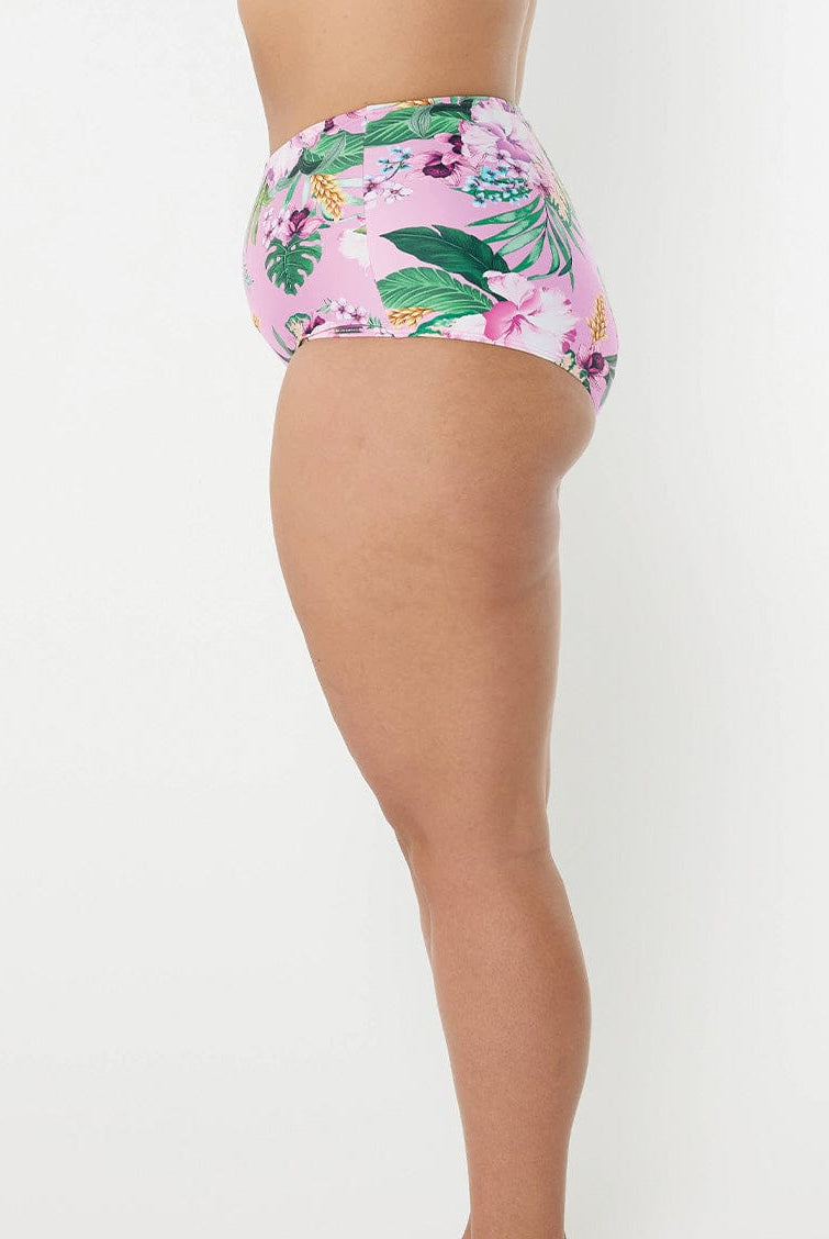 Side profile of woman wearing high waisted swim pant in tropical print for curve woman