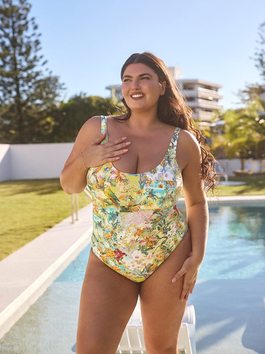 Woman wearing a floral swimsuit by a pool