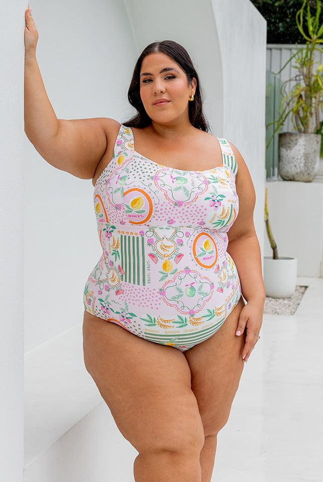 Brunette plus size model wearing square neck one in bright fruit print