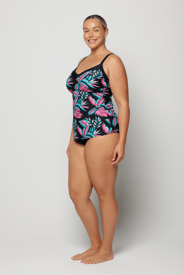 Woman wearing a floral-patterned swimsuit on a white background