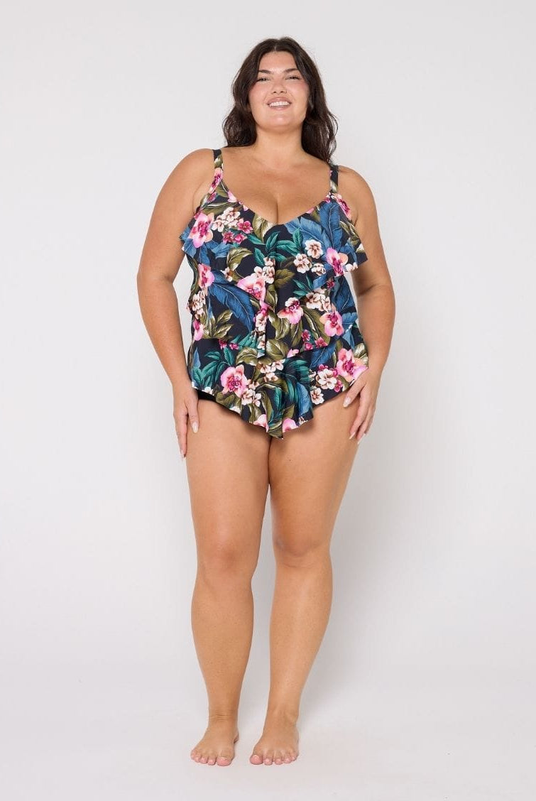 Woman wearing a tiered tankini top in floral print in studio