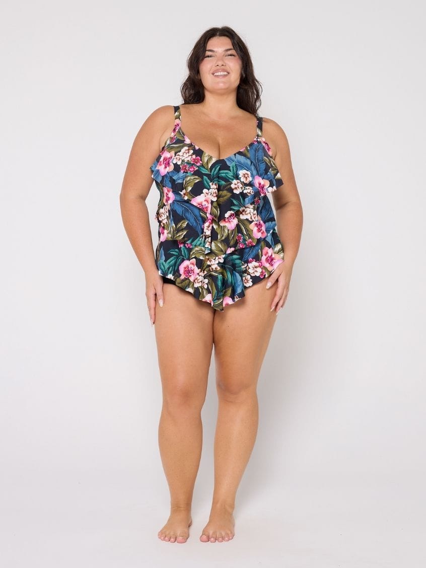 Woman wearing a tiered tankini top in floral print in studio
