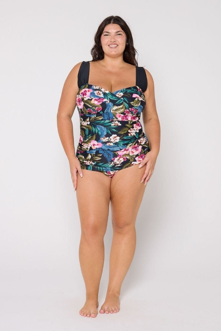 Woman wearing a retro style floral swimsuit on a white background