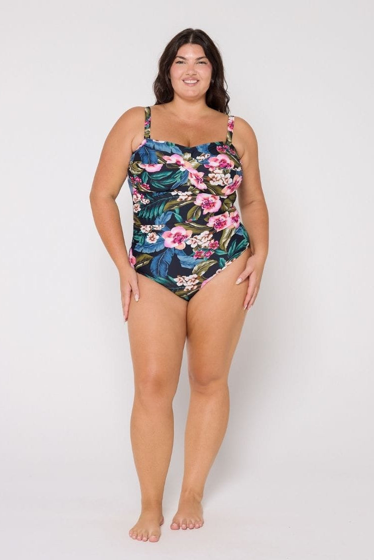 Woman wearing a floral swimsuit on a white background