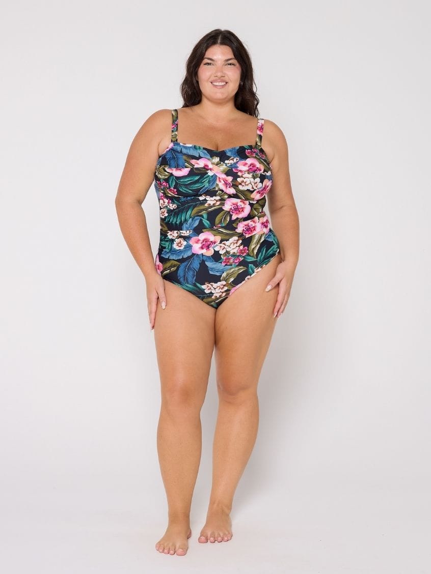 Woman wearing a floral swimsuit on a white background