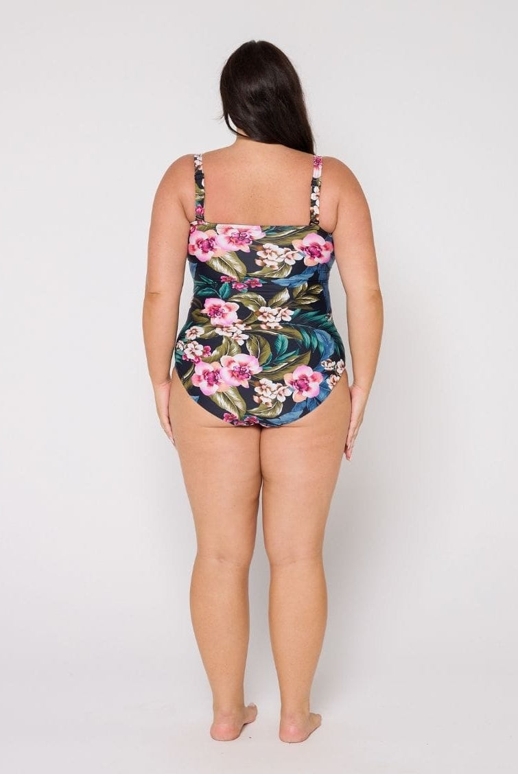 Woman wearing a floral swimsuit on a white background
