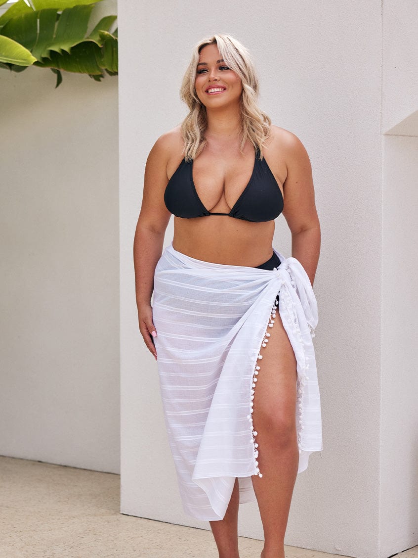 Blonde model wearing plus size sarong with tie detail in white cotton