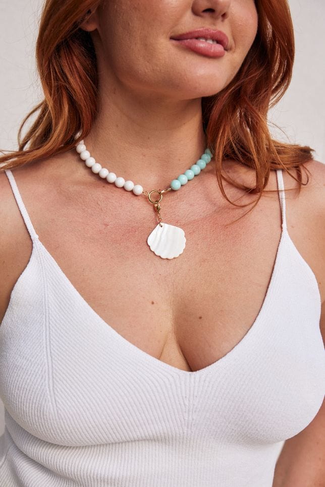 Plus size women wearing handmade buildable necklace in white with hanging charms