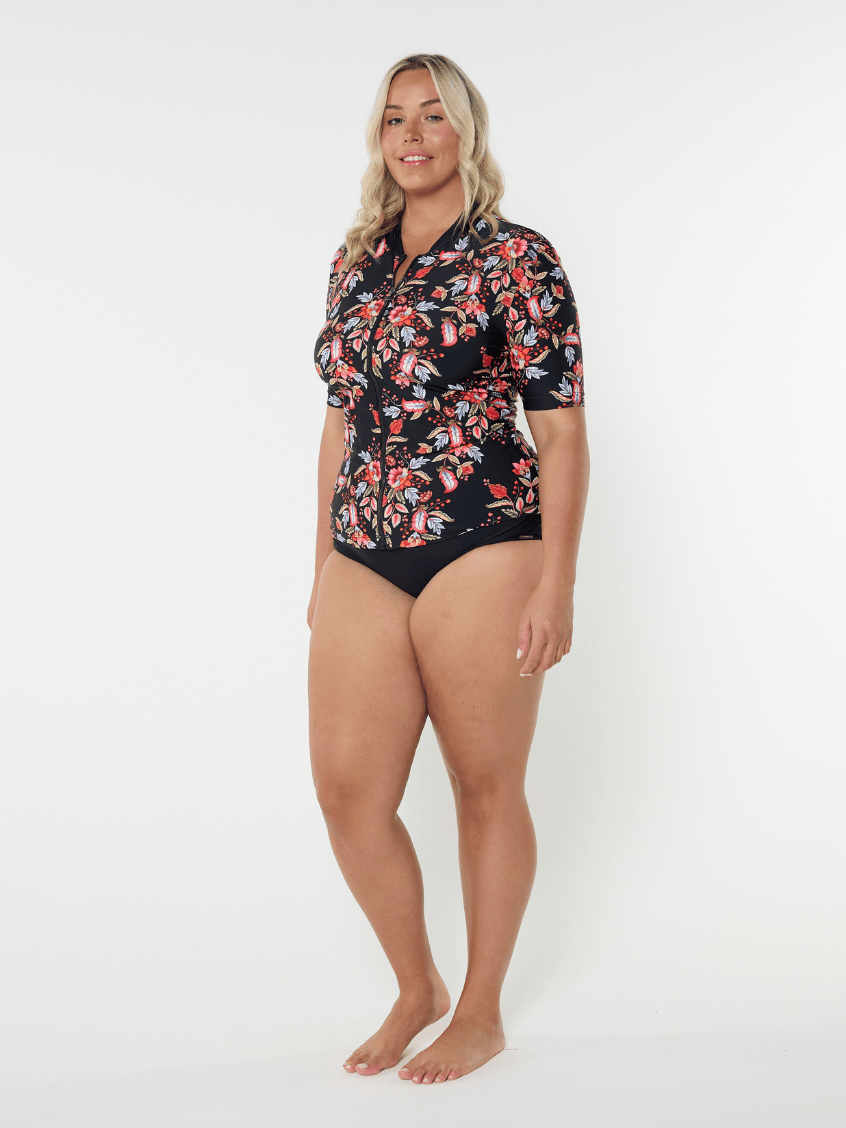 Woman wearing a floral swimsuit on a white background