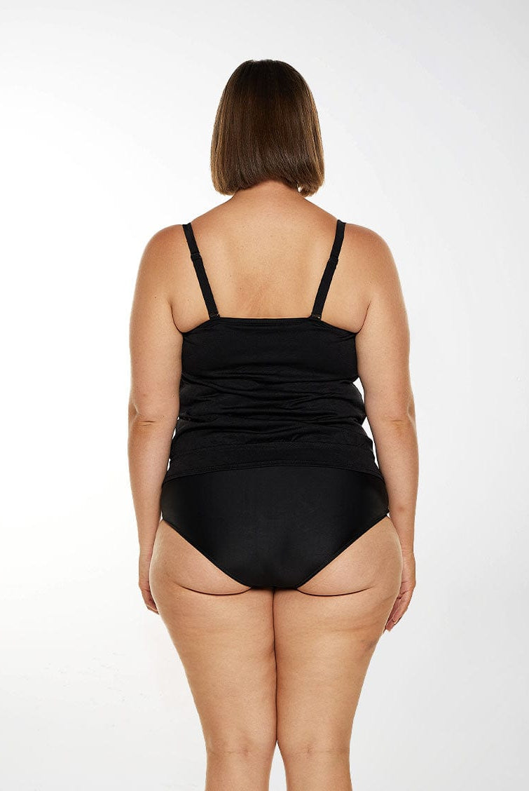 Model wears black tankini with adjustable straps