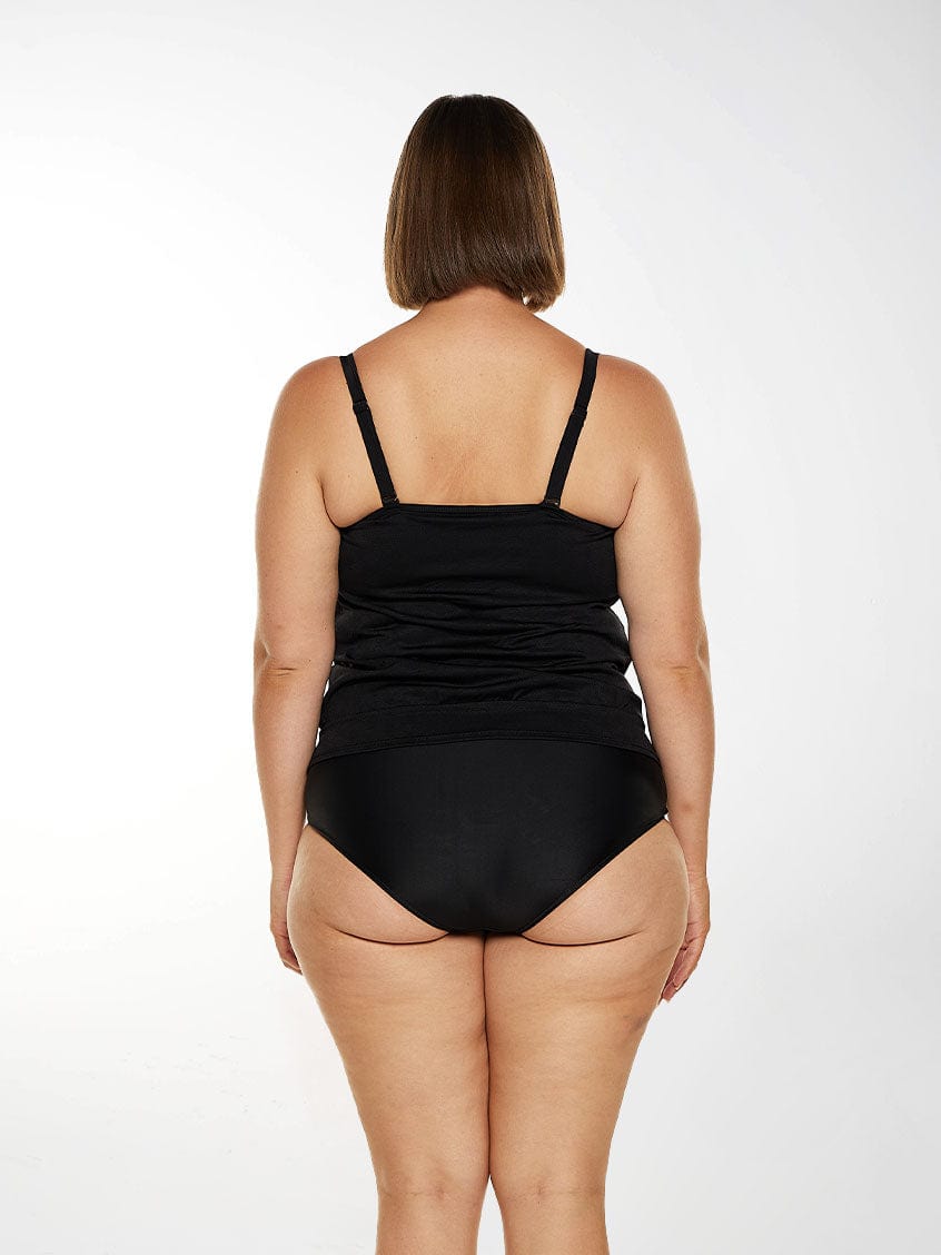 Model wears black tankini with adjustable straps