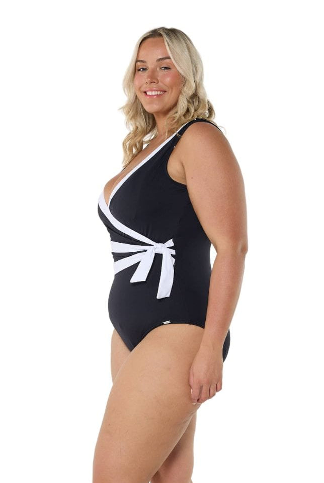 Model showing side of black and white waist tie one piece