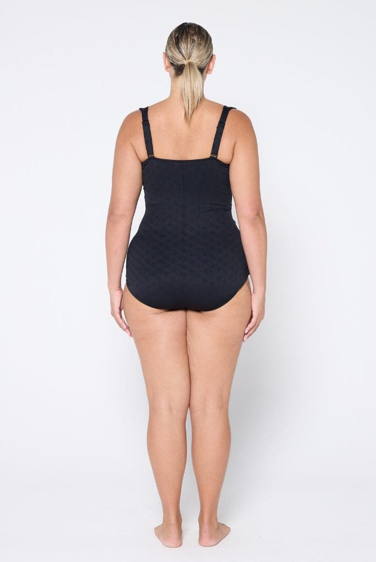 Person wearing a black swimsuit on a white background
