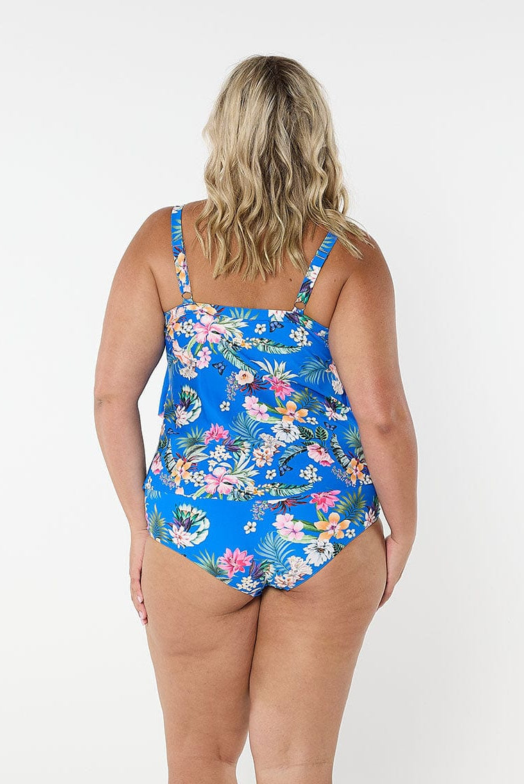 Blonde women wears flattering blue floral tankini top with adjustable straps and shelf bra