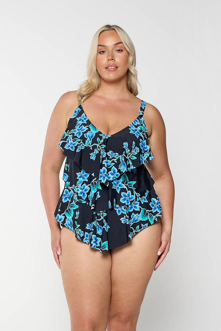 Blonde model shows front of blue floral tankini top with 3 tier ruffles