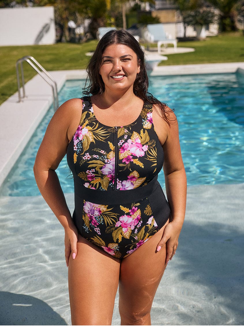 Lady in a floral swimsuit standing in a pool