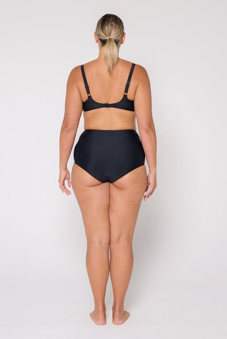 Person wearing a black bikini set on a white background