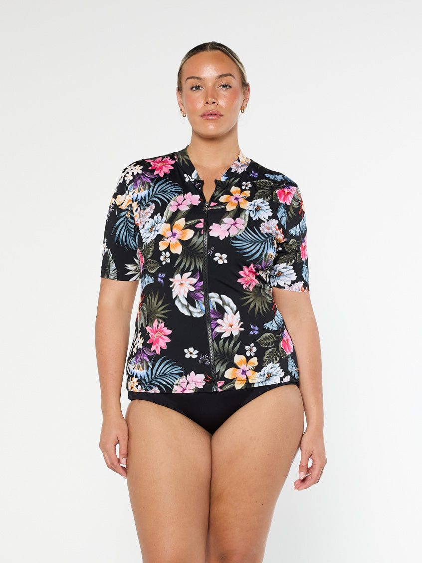 Model shows front of black floral pool proof rash vest with full zip and short sleeves