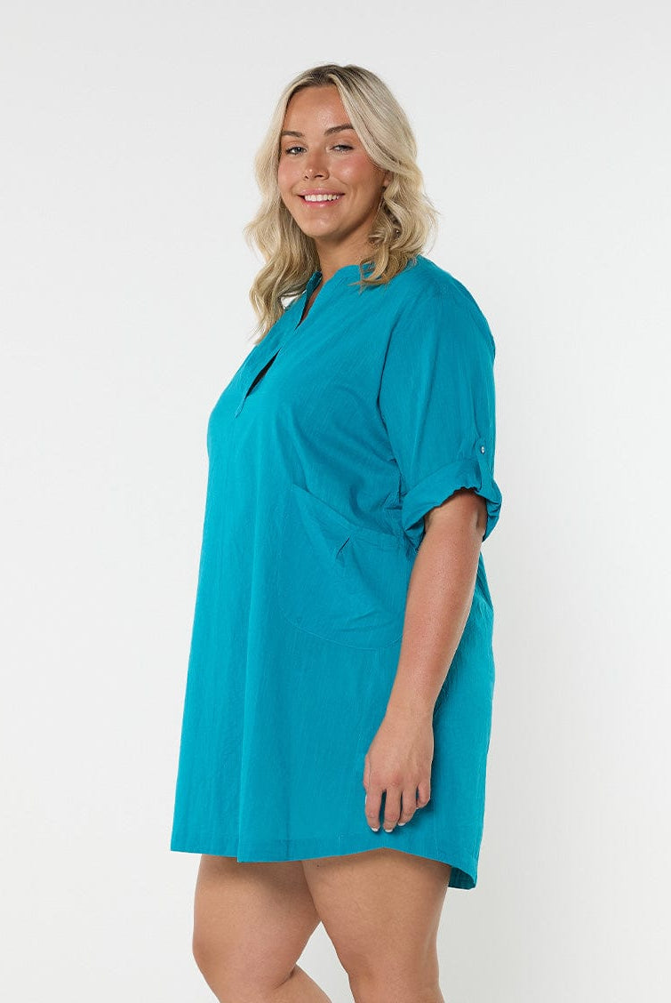 Blonde model showing side of teal over shirt