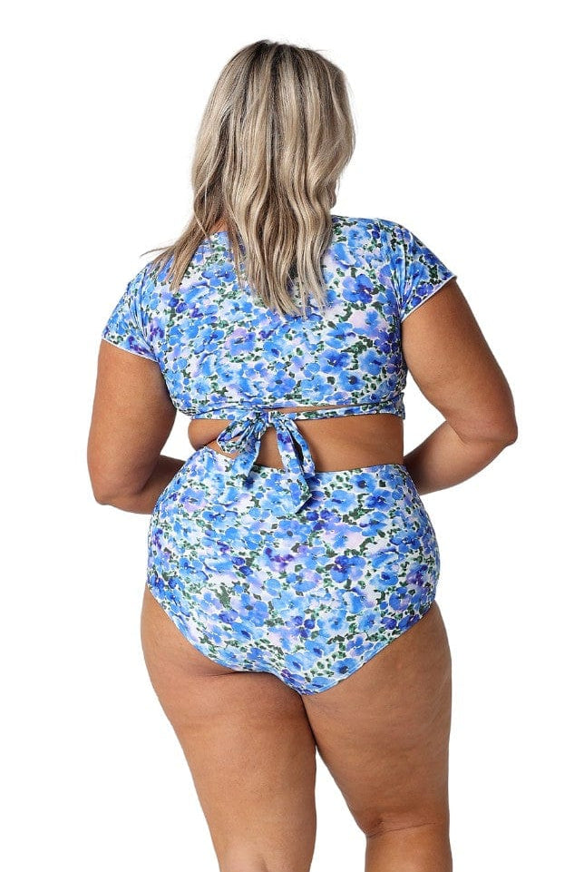 Back of curve model in studio wearing wrap bikini top in floral print