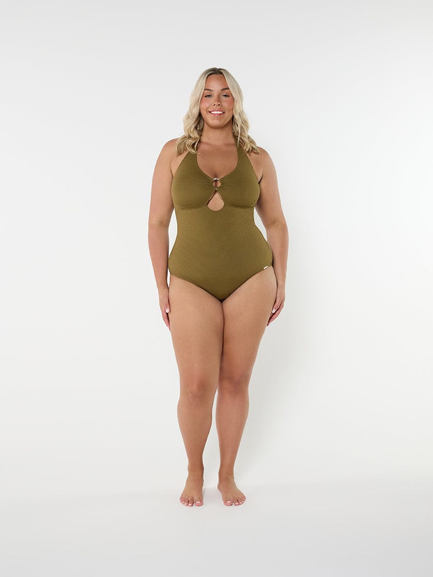 Woman wearing a green swimsuit on a white background
